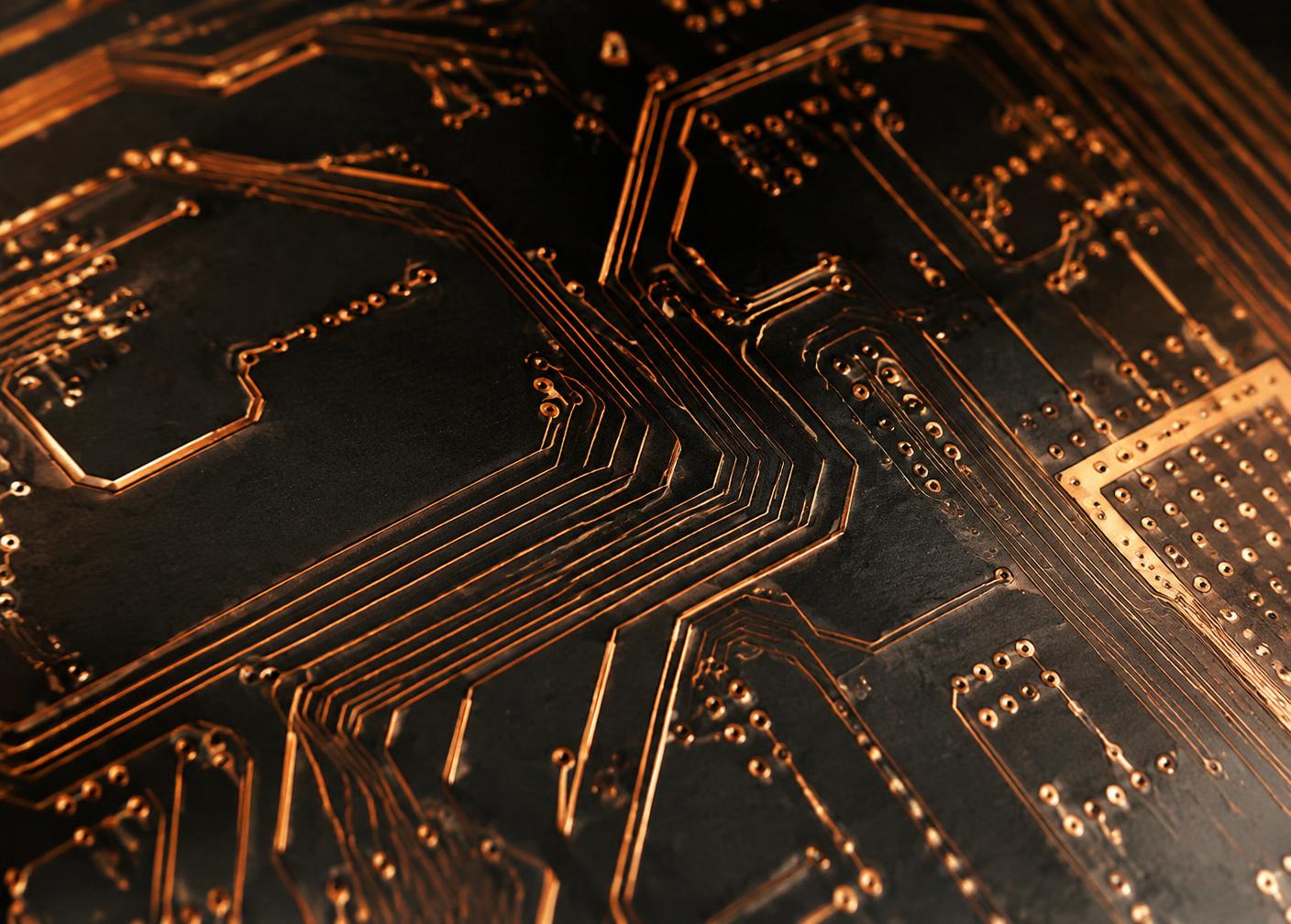 Close-up of copper circuitry on a dark board